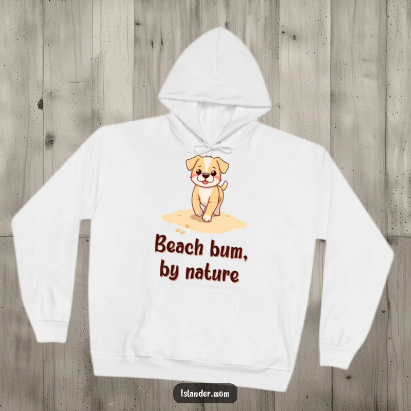 Funny dog hoodie depicting a dog leaving paw prints as it strolls along a serene sandy beach, capturing a peaceful moment.